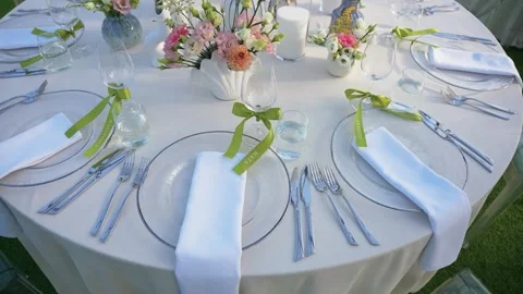Elegant Outdoor Table Setting with Floral Arrangements for Garden Event Stock Footage 345234552