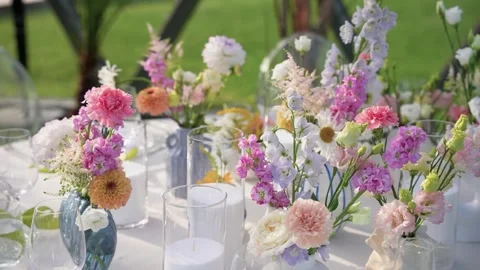 Elegant Outdoor Table Setting with Vibrant Spring Floral Arrangements Stock Footage 345233826