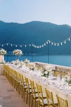 Elegant outdoor wedding dinner setup by the sea Stock Photos