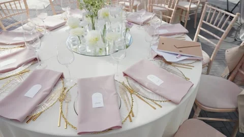 Elegant Outdoor Wedding Reception Table Setting With Pastel Decor and Floral Stock Footage 336385371