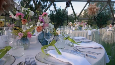 Elegant Outdoor Wedding Reception Table Decor with Floral Centerpieces Stock Footage 345233811