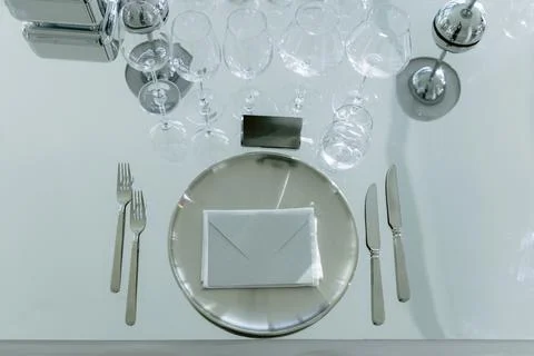 Elegant overhead table setting with plates, glasses and silverware Stock Photos