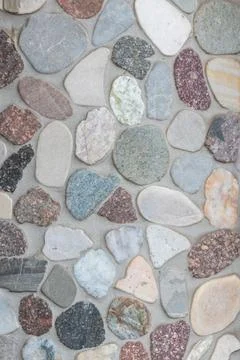 Elegant pebble background with river pebbles decorative wall design in concrete Stock Photos