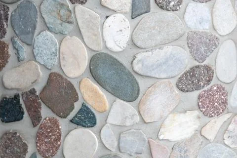 Elegant pebble background with river pebbles decorative wall design in concrete Stock Photos