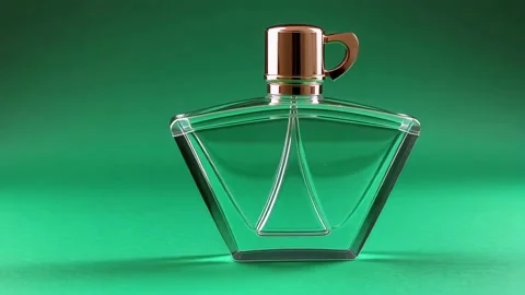 Elegant perfume bottle with geometric design against a green background Stock Footage 317912013