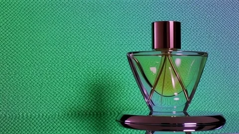 Elegant perfume bottle with geometric design against a textured backdrop Stock Footage 317912018
