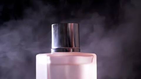 Elegant Pink Perfume Bottle Covered In Swirling Mist On Black Background Stock-Footage 330110522