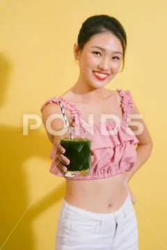 Elegant pretty slim woman drinks green detox. Stock Photos