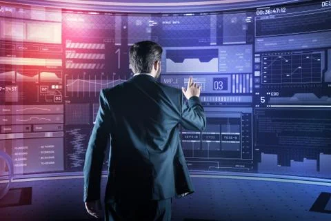 Elegant programmer pointing to the screen while working in his futuristic office Stock-Fotos