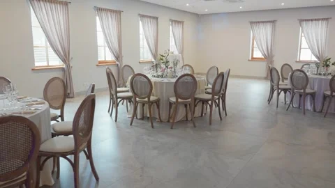 Elegant Reception Hall with Round Tables and Floral Decor, Sunlit and Ready for Видео 336364859