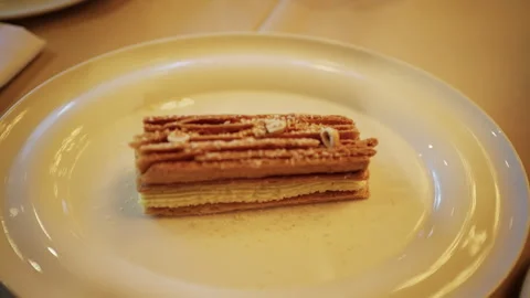 Elegant rectangular mille feuille dessert with layers of crispy puff pastry and Stockbeeldmateriaal 335227738