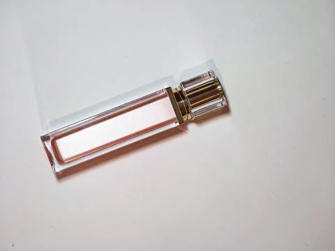 Elegant rectangular pink perfume bottle with transparent faceted cap on whit Stock Photos