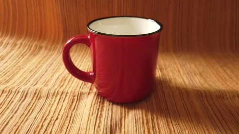 Elegant red ceramic mug with a glossy finish Stock Footage 310814596