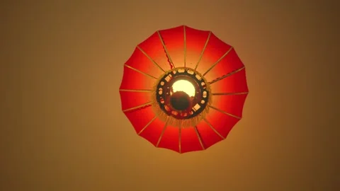 Elegant red lantern illuminating a tranquil space in the evening Stock Footage 296188241