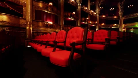 Elegant red seating in an old opera house before a performance Stock Footage 327864962