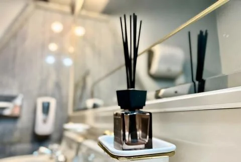 Elegant reed diffuser in a modern bathroom setting. Stock Photos
