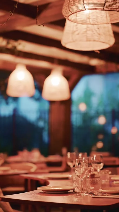 Elegant restaurant dining room interior with warm ambient lighting and blur.. Stock Footage 339472869