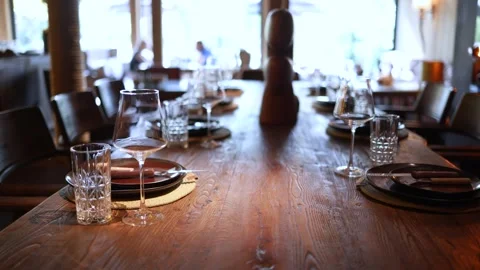Elegant restaurant table set beside large windows Stock Footage 344744649