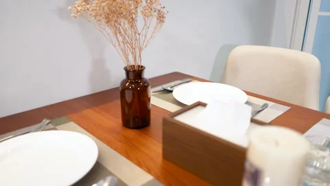 Elegant Restaurant Table Setting with Dried Flowers and White Candle Stock Footage 334984740