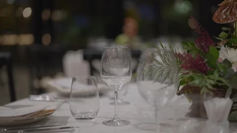 Elegant restaurant table setting with wine glasses and soft bokeh lights. Stock-Footage 322900244