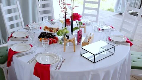 Elegant round dining setup with crisp white tablecloth, pristine dinnerware Stock Photos