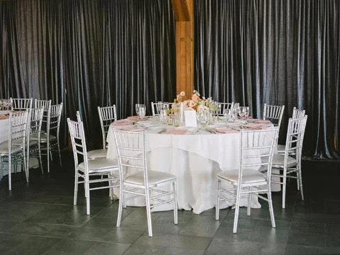 Elegant round dining table set for a formal event in an upscale indoor venue Stock Photos