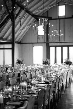 Elegant rustic wedding dinner setup in barn venue Stock Photos