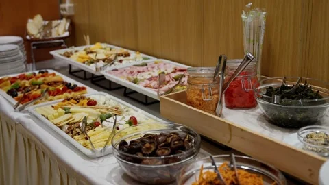 Elegant self-serve buffet spread with assorted cheeses, cold cuts, fresh fruit Stock-Footage 321363659