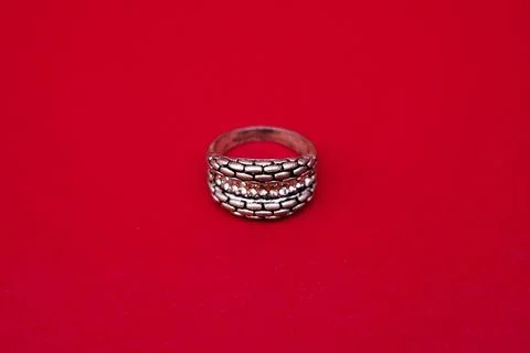 Elegant Silver Ring with Gemstone on Red Background Stock Photos