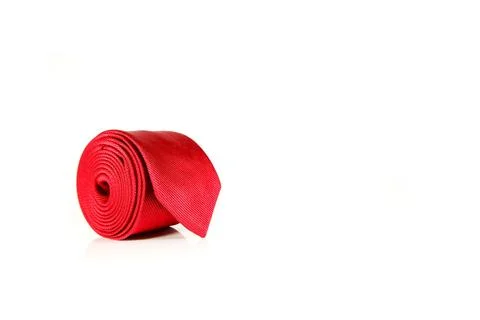 Elegant solid red polyester fabric necktie rolled over white background 스톡 사진