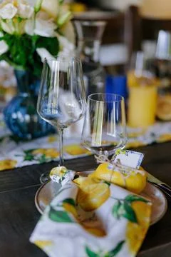 Elegant Summer Table Setting with Lemons and Fresh Flowers. Stock Photos