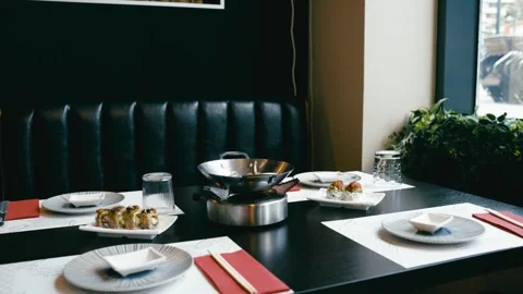 Elegant sushi dinner setting in a modern japanese restaurant Stock Footage 337883181