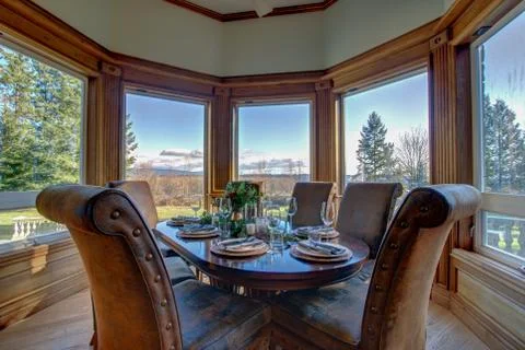 Elegant table set for dinner with beautiful view from the windows. Stock Photos