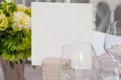 Elegant Table Setting with Blank Card and Flower Arrangement Stock Photos