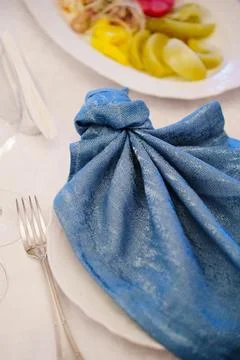 Elegant table setting with blue napkin and plate at dining event Stock Photos