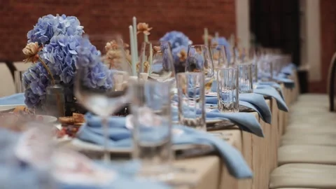 Elegant table setting with blue napkins and glassware, close-up of wedding or Stock Footage 320374090