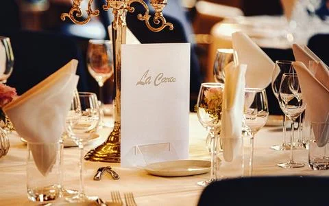Elegant Table Setting with Candlestick and La Carte Menu for Formal Dining .. Stock Photos