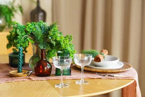 Elegant table setting with crystal glasses and plates with festive holiday .. Stock Photos