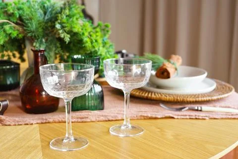 Elegant table setting with crystal glasses and plates with festive holiday .. Stock Photos