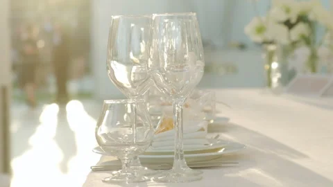 Elegant table setting with exquisite glassware, floral decor, and soft lighting Stock Footage 317874897