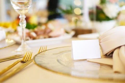 Elegant table setting featuring blank place cards on fine china plates Stock Photos