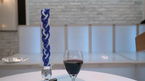 An Elegant Table Setting Featuring Wine and a Beautiful Decorative Candle for Stock Footage 295008331