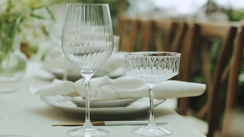 An Elegant Table Setting Featuring Wine and Coupe Glasses for an Unforgettable Stock Footage 308398206