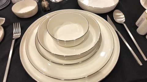 Elegant table setting with fine dinnerware and silver utensils Stock Footage 305437546