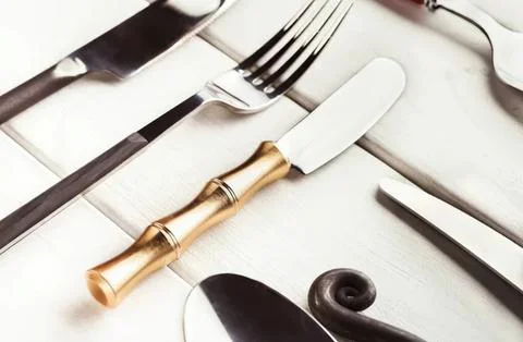 Elegant table setting with fork knife and spoon on white table Stock Photos