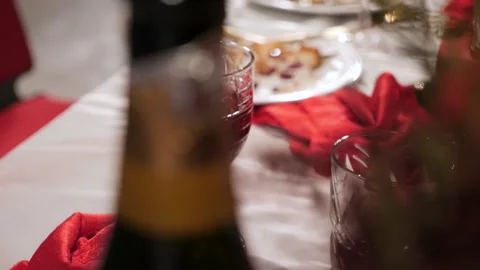 Elegant table setting with glass of red wine and champagne bottle for celeb.. Stockbeeldmateriaal 337171947