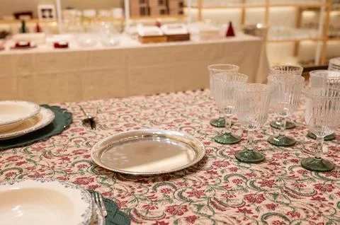 Elegant table setting with glassware and vintage pattern tablecloth in dini.. Stock Photos