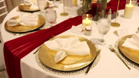 Elegant table setting with gold plates and candles Stock Footage 337498940
