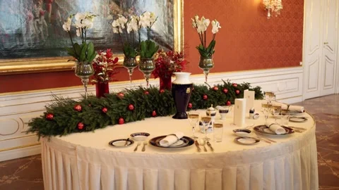 An elegant table setting in a lavishly decorated room features festive garlands, Stock Footage 294771433