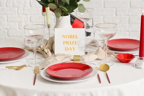 Elegant table setting for Nobel prize day with flowers and candles in dining  Stock Photos